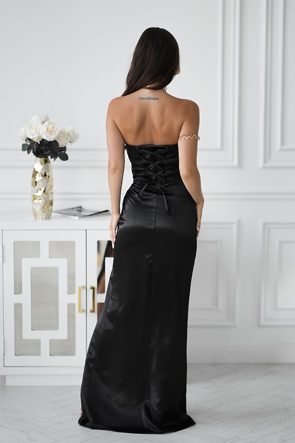 Back view of Bicotone black strapless long satin dress with corset lace-up detail